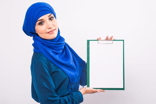 Beautiful Muslim fashion girl holding an empty banner, copy-space.