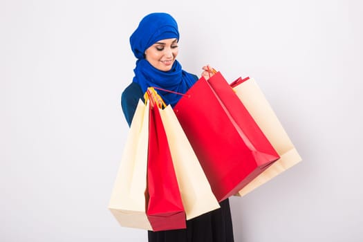 Arab or Muslim woman with shopping bags