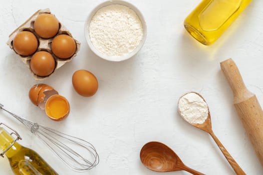Preparation for baking. Eggs and flour on white background