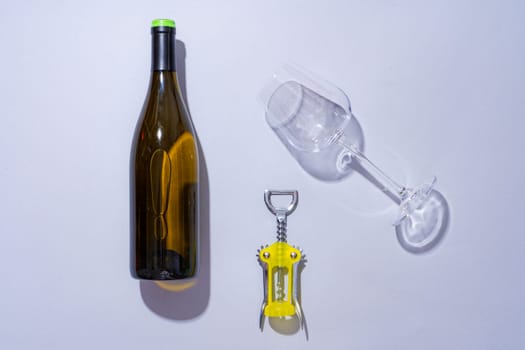 Wine bottle and glass on gray background flat lay
