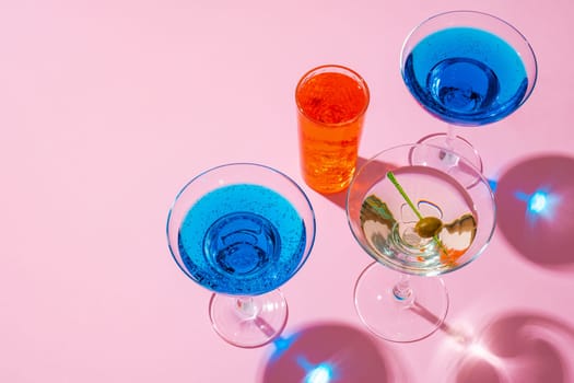 Cold and refreshing cocktails on color background