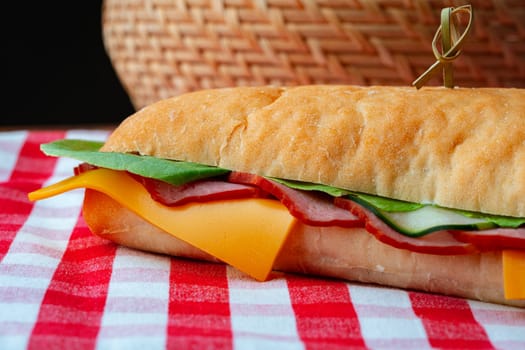 Ham sandwich with cheese and lettuce on table