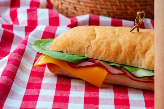 Ham sandwich with cheese and lettuce on table