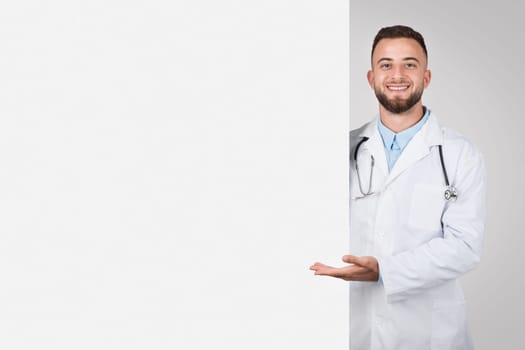 Doctor presenting with hand, half space for text