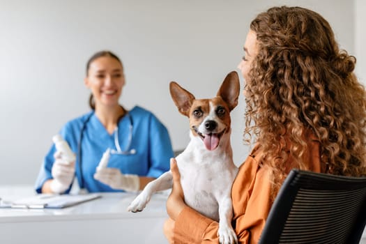 Dog with owner at vet's office smiling