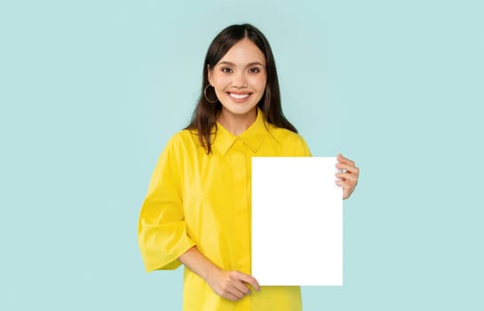 Positive millennial woman showing vertical blank placard