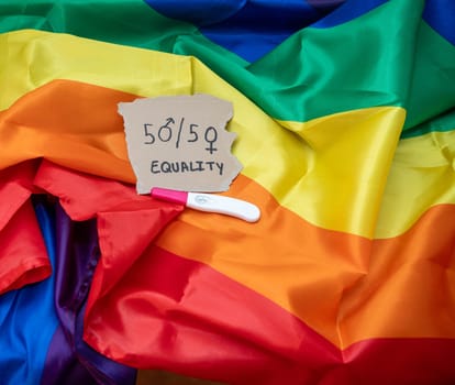 cut-out with the phrase 50 percent equality, on a pride flag along