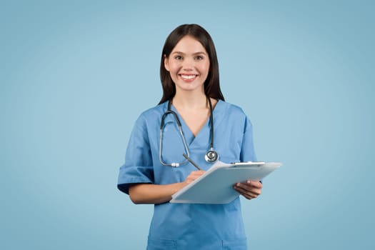 Smiling female nurse with clipboard and stethoscope