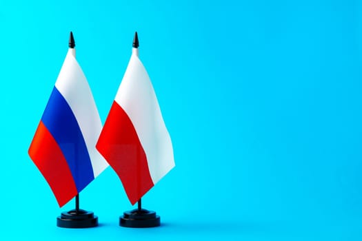 Flags of Poland and Russia on blue background