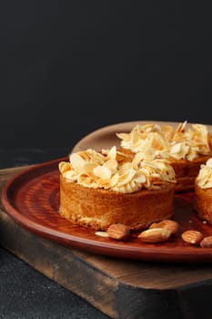 Tart pie with almond petals on plate