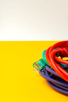 Network cable on yellow background studio shot