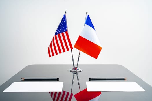 Flags of USA and France on negotiation table