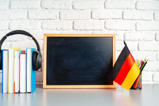 Blackboard and German flag on school desk