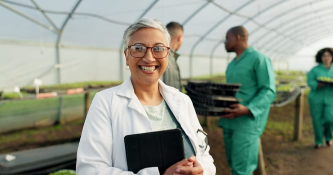 Portrait, botanist and happy woman at greenhouse with tablet tech for science at farm, plant and ecology. Face, smile and mature scientist at nursery for agriculture in glasses for research in Mexico