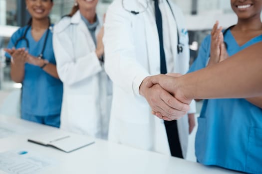 Doctors, nurses and handshake success in medical partnership, insurance deal or healthcare support in hospital. Zoom, hands or consulting medicine workers in welcome, thank you or trust collaboration
