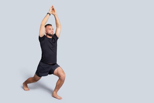 Positive strong young european guy in sportswear practice yoga, breath exercises