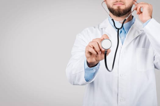 Close-up of male doctor with stethoscope, free space