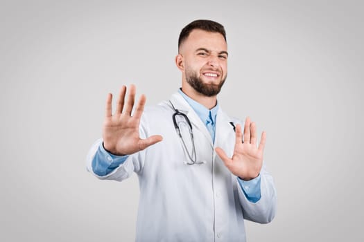 Man doctor gesturing stop with hands