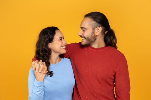 Smiling millennial couple in casual flirt, hugging