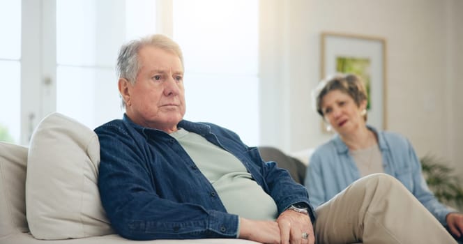 Senior, couple or stress with conflict and fight on sofa in living room of home with anger and silence. Elderly, man or woman with argument, upset and frustrated on couch in lounge of house or ignore