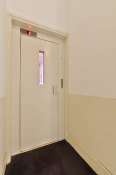 a white door with a window in a white room