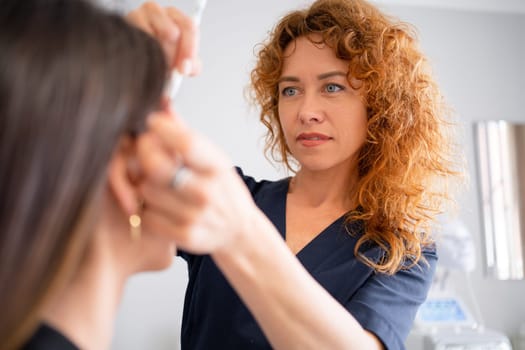 Female dermatologist performing procedure on client