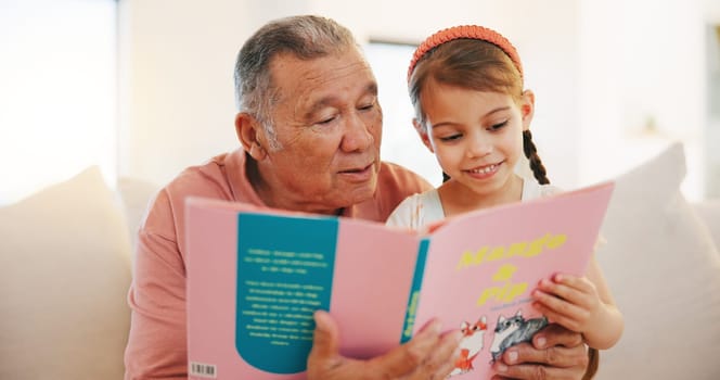 Grandfather, child and reading book on sofa for literature, education or bonding together at home. Grandparent with little girl or kid smile for story, learning or relax on living room couch at house