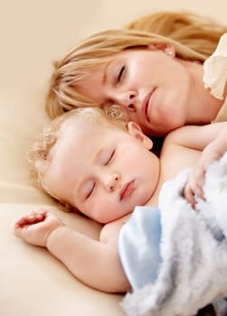 Sleeping, mom and baby with peace in bed together with calm moment with love for infant and kid in morning nap. Mother, cuddle and sleep with child in closeup and rest in bedroom or family home