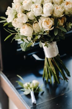 Wedding bouquet of roses lying on the surface. Wedding floristry
