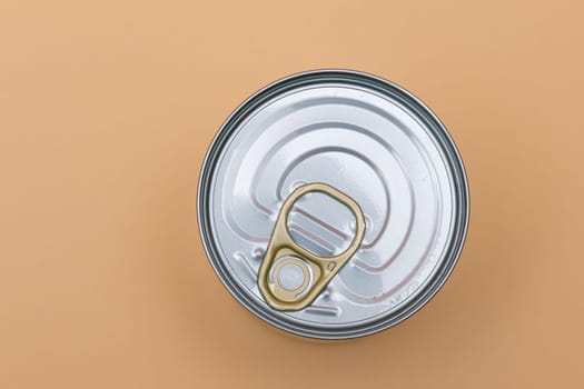 Unopened Tin Can with Blank Edge on Beige Background