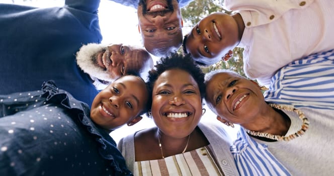 Happy, huddle or portrait of a black family in nature for fun bonding or playing in a park together. Smile, support or below of mother with grandparents, father or children to hug or relax on holiday
