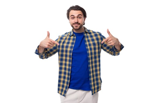 smart brunette macho man with a beard and mustache in a blue shirt on a white background with copy space
