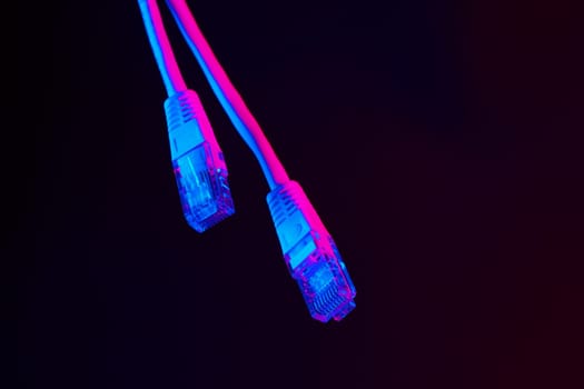 Modern technology network cable in neon light.