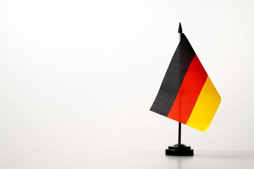 Small flag of Germany on flagpole close up
