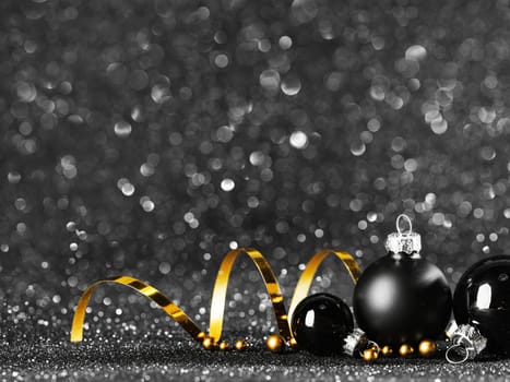 gold and black christmas balls on black bokeh
