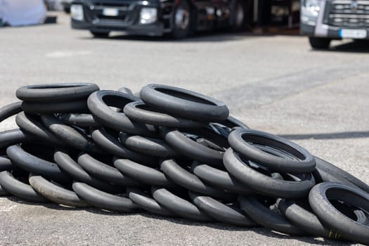 A Towering Stack of Rubber: A Pile of Tires in the Center of a Parking Lot
