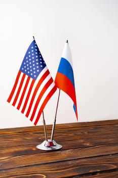 Small flags of Russia and USA on flagpoles close up
