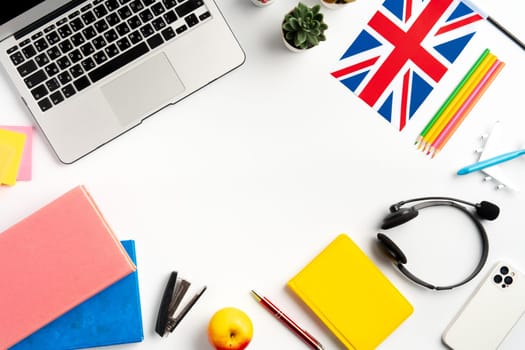 Laptop and flag of UK on desk. English language learning concept