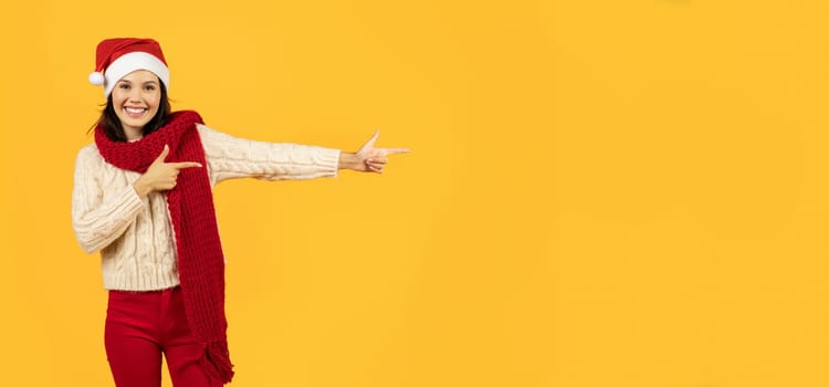 Lady pointing aside to empty space on yellow studio background
