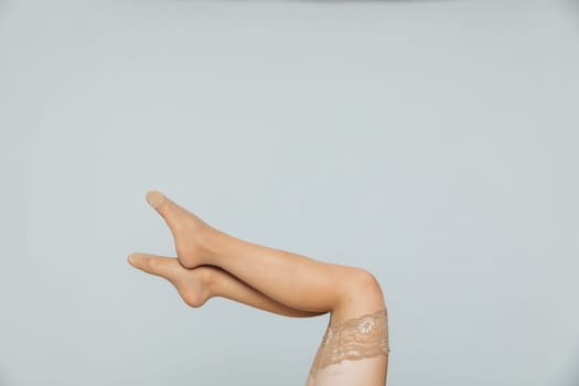 the women's slender legs in beige stockings