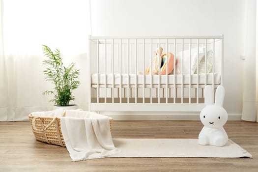 Interior of nursery room with baby crib and cradle
