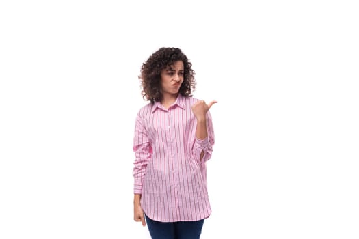 young well-groomed brunette woman in a pink shirt with a grimace isolated on white background