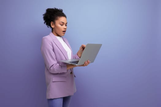 young smart hispanic brunette leader woman with curly hair in jacket uses laptop for business affairs