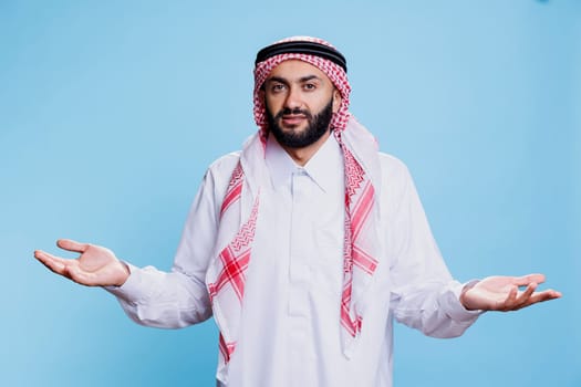 Confused muslim man shrugging shoulders