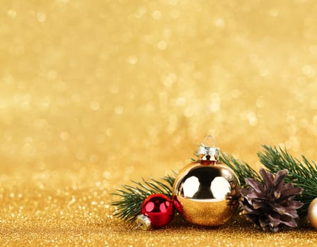 red and gold balls and fir on bokeh background