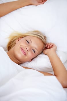 Person, portrait or wake up in home bedroom for relax, sleeping and weekend rest. Smile, awake or happy woman lying or stretching in house, hotel or apartment bed for comfort break in morning rotine