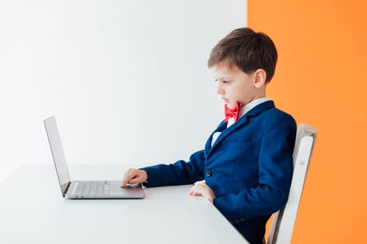 Boy in the classroom at the laptop online education skype communication