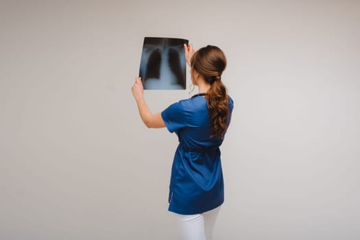 Female Brunette Doctor Looking at Tomography X-ray Film