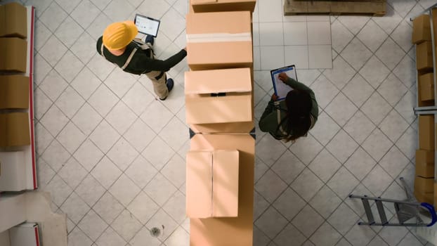 Warehouse coordinators examine parcels