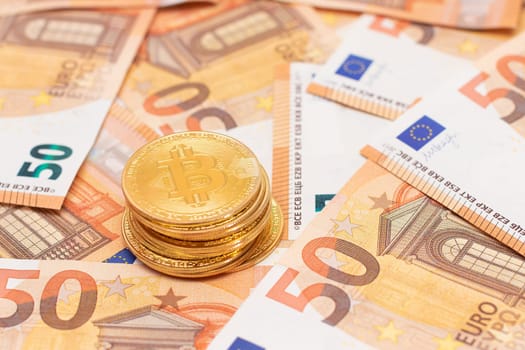 A Stack of Bitcoin Coins on the 50 Euro Banknotes
